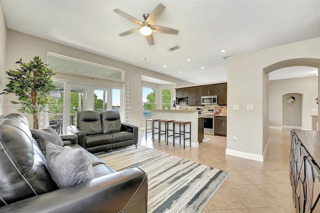 tiled living room with ceiling fan