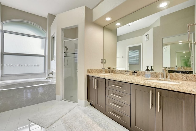 bathroom with tile patterned flooring, shower with separate bathtub, and vanity