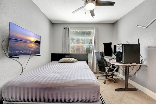 tiled bedroom with a textured ceiling and ceiling fan