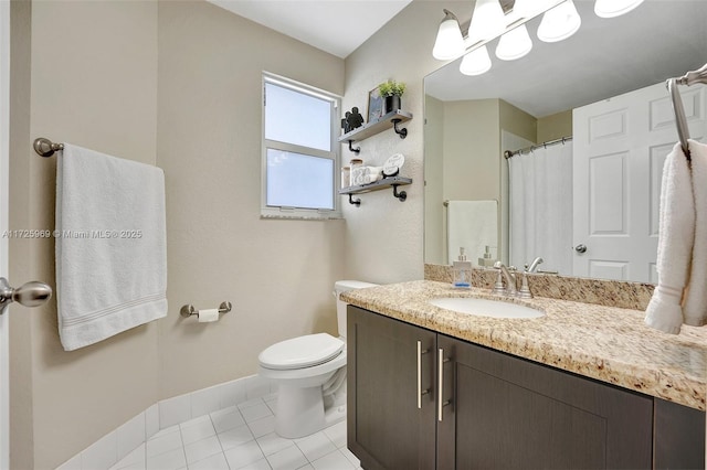 bathroom featuring toilet, tile patterned floors, and vanity