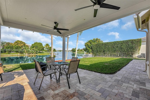 view of patio featuring ceiling fan and a water view