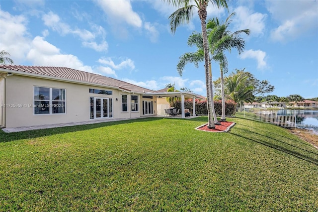 view of yard with a patio and a water view