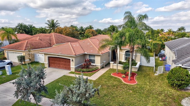 mediterranean / spanish-style house featuring a front lawn and a garage