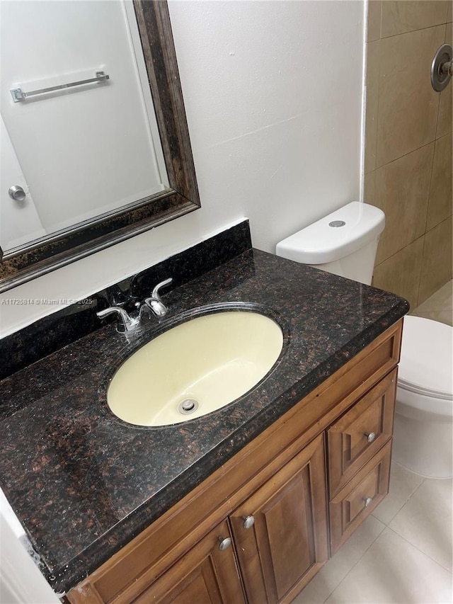 bathroom featuring walk in shower, tile patterned flooring, vanity, and toilet