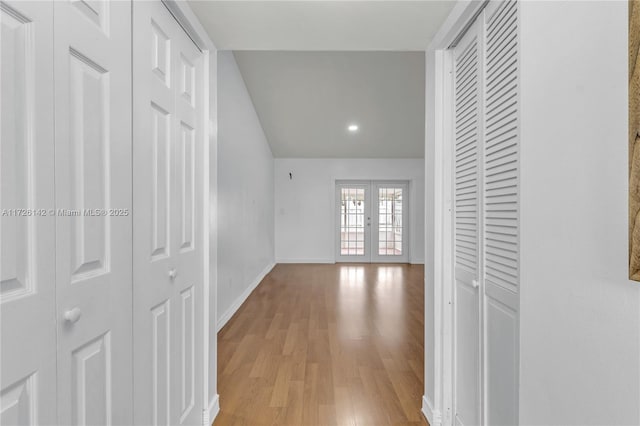 hallway with french doors and light wood-type flooring