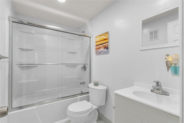 full bathroom with toilet, vanity, and bath / shower combo with glass door