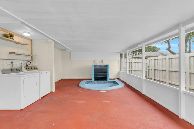 unfurnished sunroom featuring washer and clothes dryer