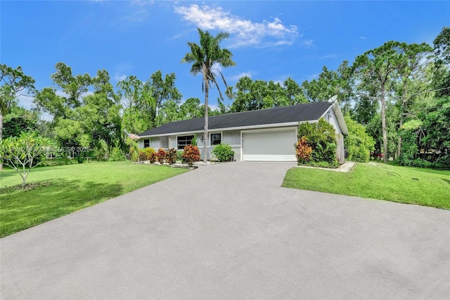 ranch-style house with a front yard and a garage