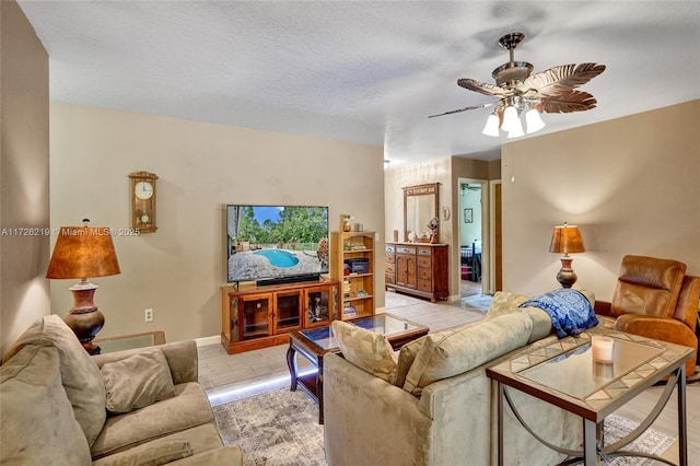 living room with a textured ceiling and ceiling fan