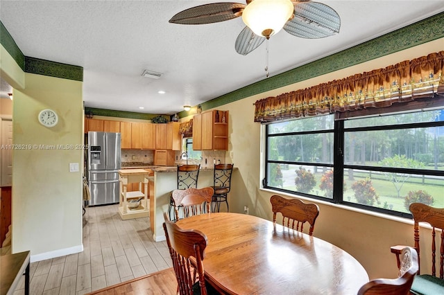 dining room featuring a textured ceiling and ceiling fan