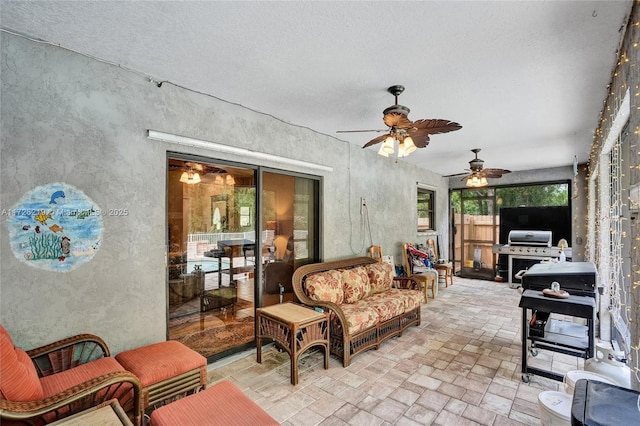 view of patio / terrace with grilling area, ceiling fan, and an outdoor living space