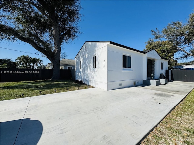 exterior space featuring a patio area and a lawn