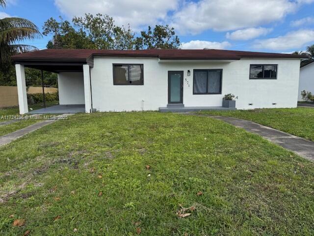 single story home featuring a front yard and a carport