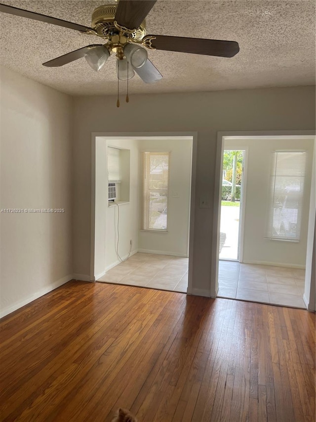 unfurnished room with ceiling fan and light hardwood / wood-style flooring