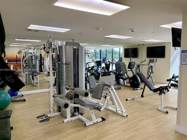 workout area with hardwood / wood-style flooring