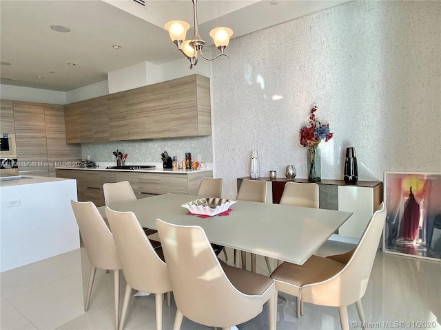 dining space with sink and a chandelier