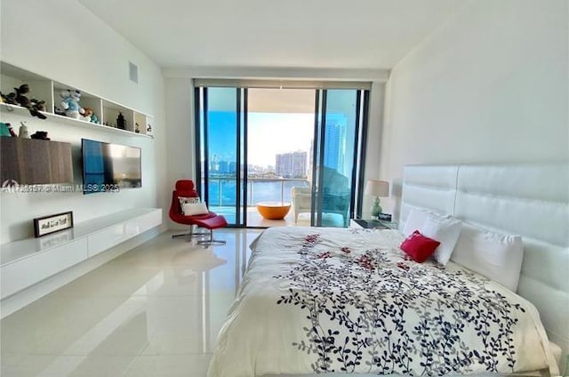 tiled bedroom featuring access to outside and a wall of windows