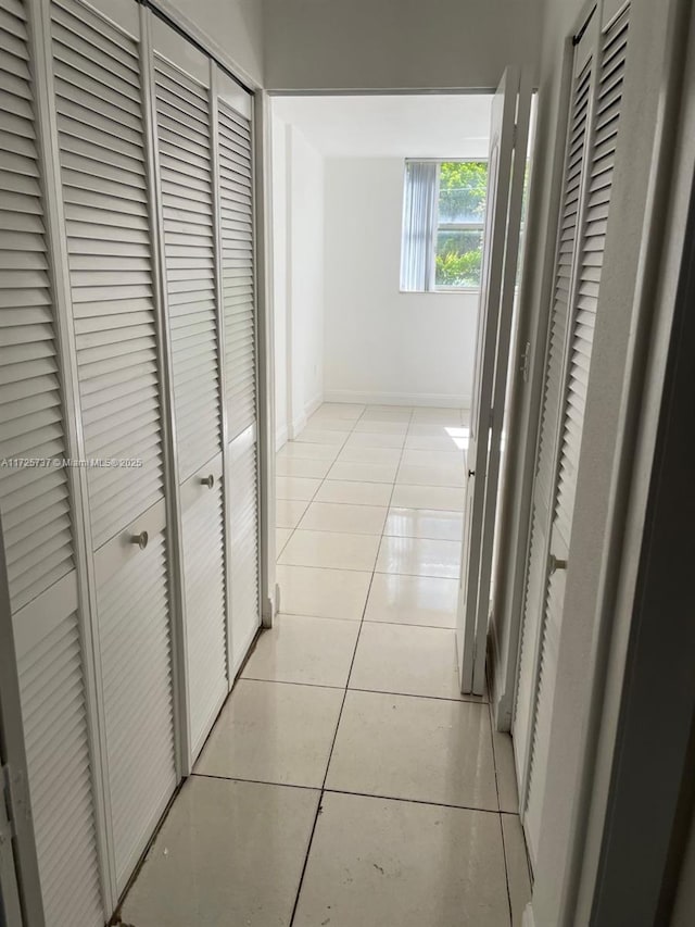 corridor featuring light tile patterned floors