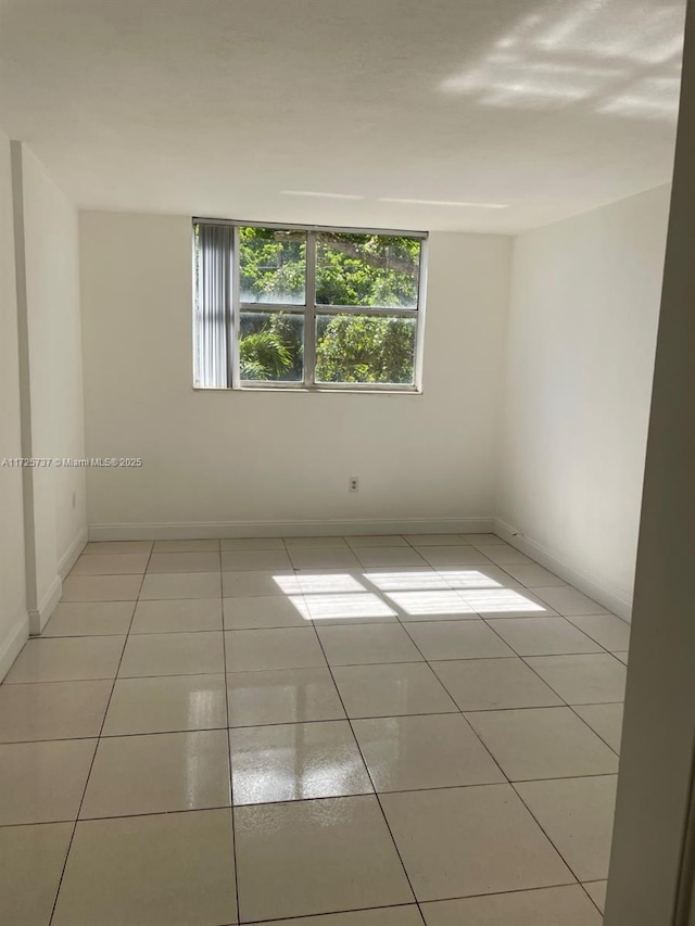 spare room with light tile patterned floors