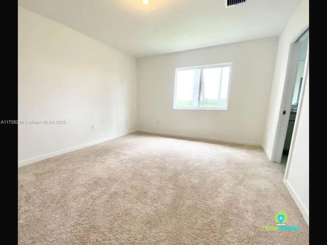 spare room with light colored carpet