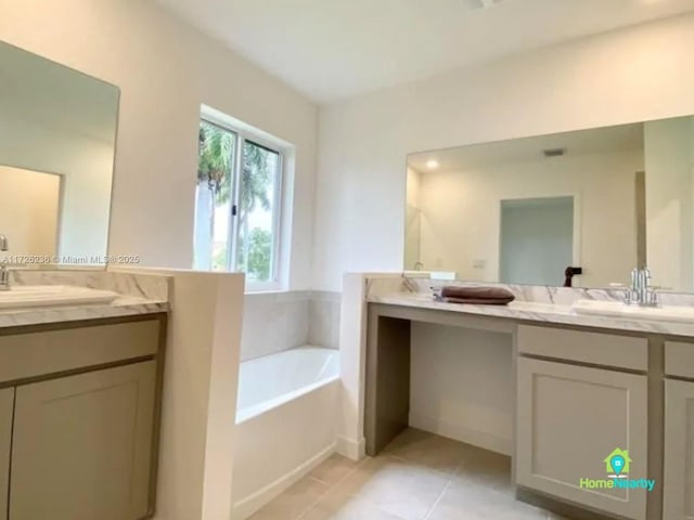 bathroom with vanity, tile patterned floors, and a tub