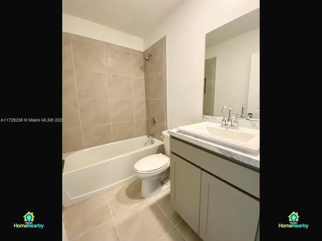 full bathroom with vanity, tiled shower / bath combo, tile patterned floors, and toilet