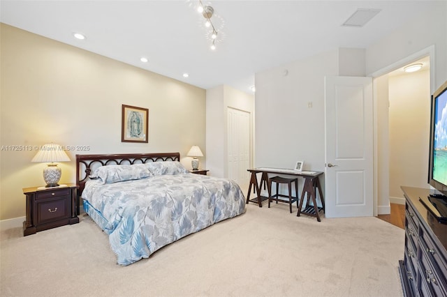 bedroom featuring light colored carpet and a closet