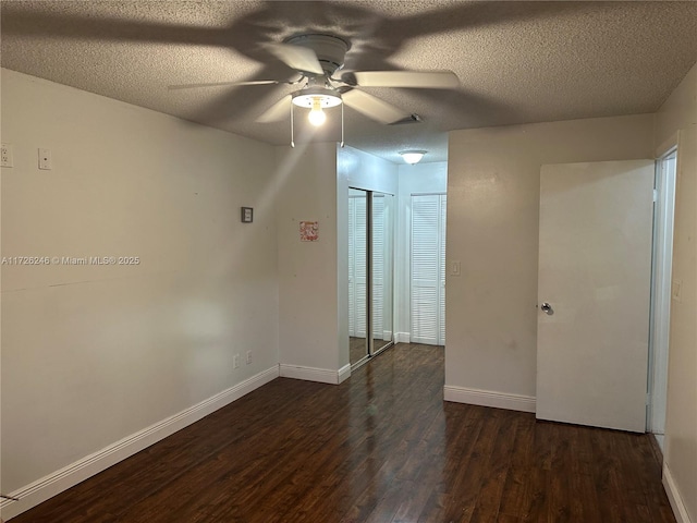 unfurnished room featuring ceiling fan, a textured ceiling, and dark hardwood / wood-style floors