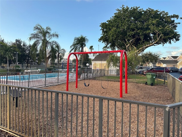 view of playground with a community pool