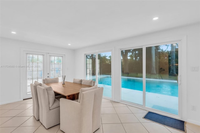 tiled dining space featuring french doors