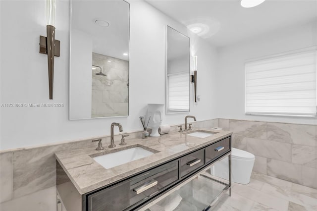 bathroom with toilet, a shower, tile walls, and vanity