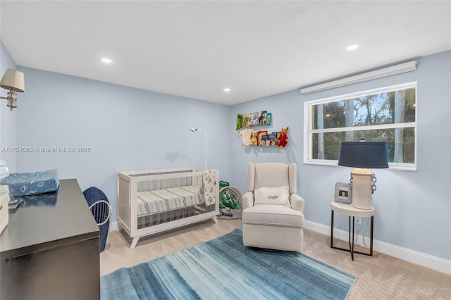 bedroom with light colored carpet and a crib