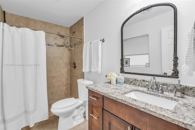 bathroom featuring curtained shower, vanity, and toilet