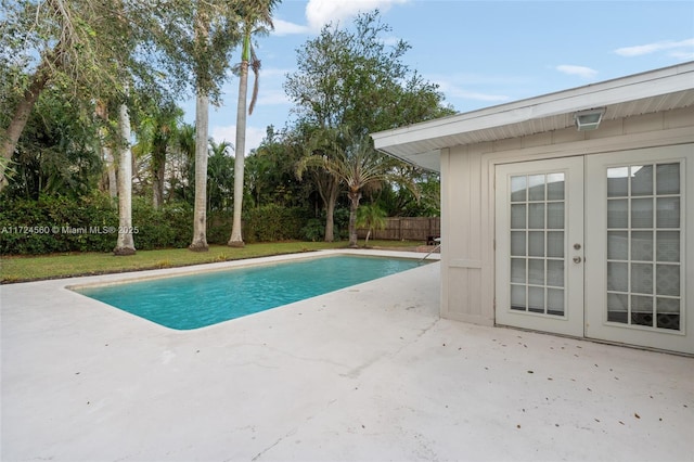 view of swimming pool featuring a patio and french doors