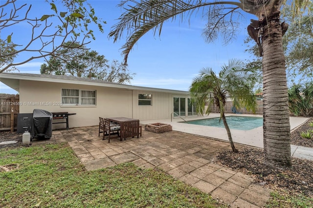 rear view of house featuring an outdoor fire pit and a patio area