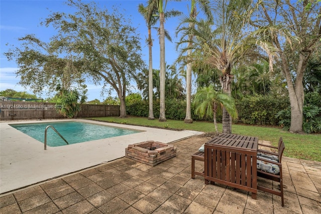 view of swimming pool with a fire pit, a yard, and a patio area