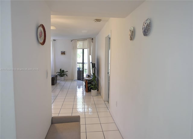 hallway with light tile patterned floors