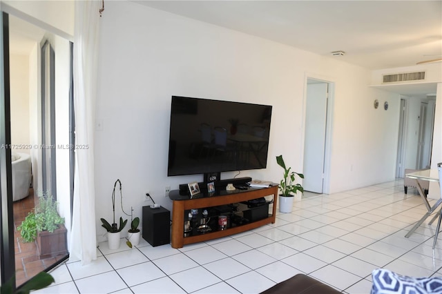 tiled living room with ceiling fan