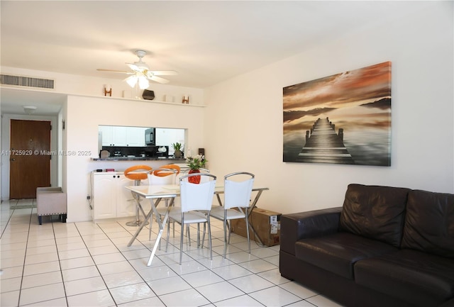 tiled dining room with ceiling fan