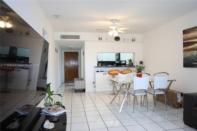 dining area with ceiling fan and light tile patterned flooring