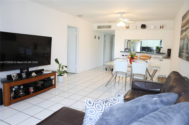 tiled living room with ceiling fan