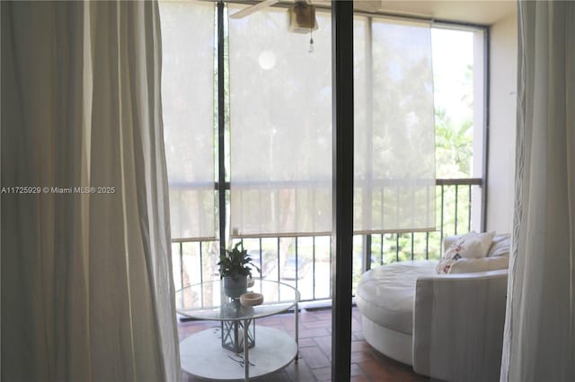 interior space with ceiling fan and expansive windows