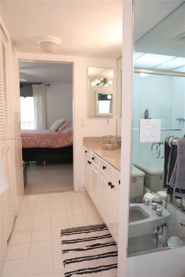 bathroom featuring toilet, vanity, and tile patterned floors