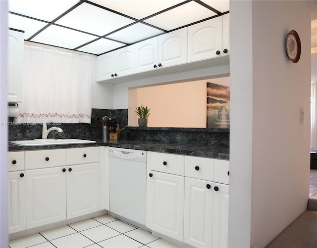 kitchen with white cabinets, dishwasher, sink, and light tile patterned floors