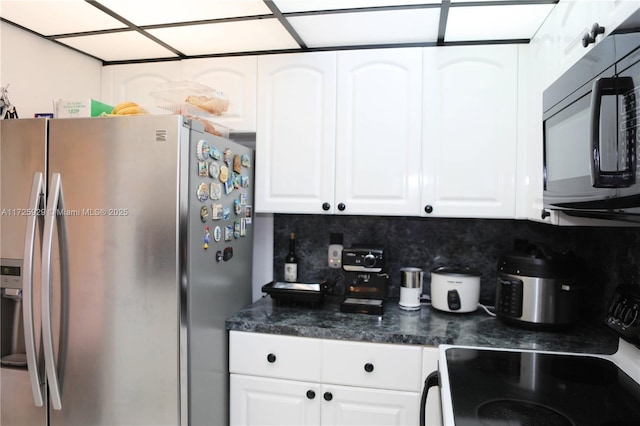 kitchen featuring white cabinets, stainless steel fridge with ice dispenser, electric range oven, and decorative backsplash