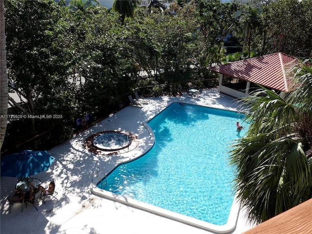 view of swimming pool featuring an outdoor fire pit, a gazebo, and a patio area