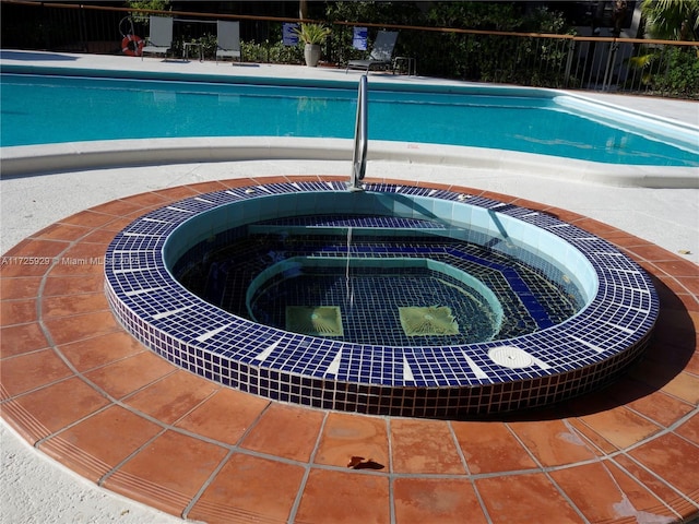 view of swimming pool featuring a community hot tub