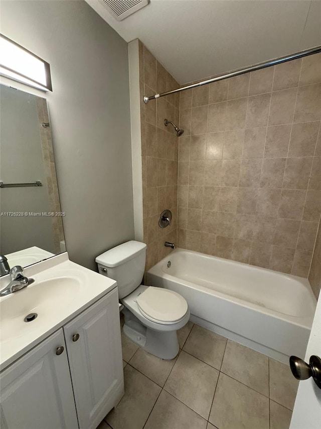 full bathroom featuring toilet, vanity, tile patterned floors, and tiled shower / bath