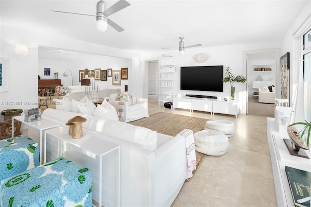 living room with ceiling fan, light tile patterned floors, and built in features