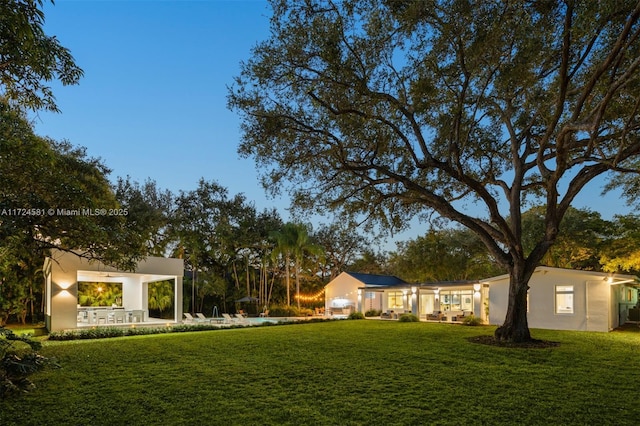 yard at dusk with a patio